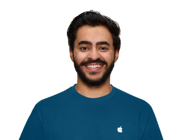 一位 Apple Store Specialist 面帶微笑，身穿藍色 Apple 上衣