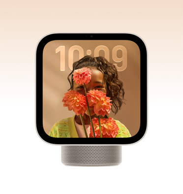 Apple HomeView, starlight colour (pale gold), screen shows time over a wallpaper of a person holding flowers